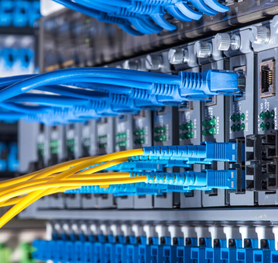 Fiber Optic cables connected to an optic ports and Network cables connected to ethernet ports